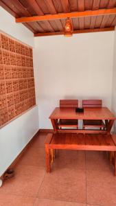 a wooden bench in a room with a table at The Royal Island in Munroe Island