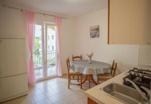 a kitchen with a table and a table and a window at Apartments Plenković in Stari Grad