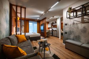 a living room with a couch and a table at Blue Sky Studio with pool and spa in Sinaia