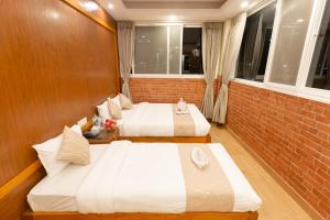 Un pat sau paturi într-o cameră la Paradise Boutique Hotel