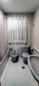 a bathroom with a toilet and a sink at Apartamento turístico en Porto do Son in Porto do Son