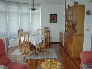 a dining room with a table and four chairs at Apartamento turístico en Porto do Son in Porto do Son +8 photos