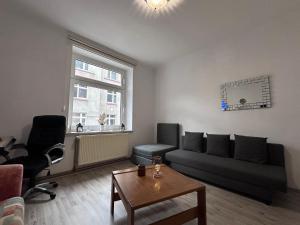 a living room with a couch and a table at Geräumige Wohnung Dortmund City in Dortmund