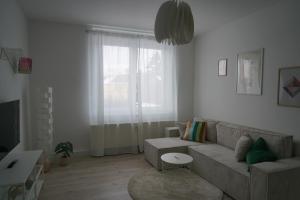a living room with a couch and a window at Apartment Carla in Senftenberg