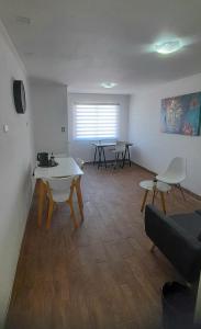 a living room with a table and chairs in it at Hostal Tabancura in Copiapó