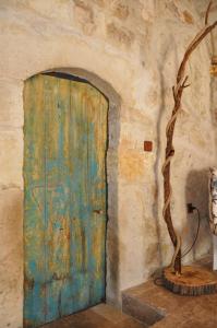 a wooden door with a tree in front of it at cemil köyü cave house in Urgup