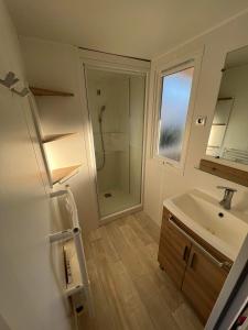 a bathroom with a sink and a shower at mobilhome 6/8 pers. camping siblu les charmettes in Les Mathes