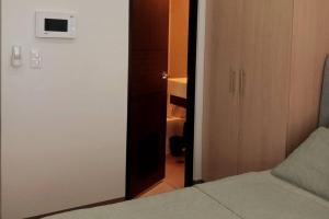a bedroom with a door leading to a closet at Condo with Balcony in Iloilo City in Iloilo City