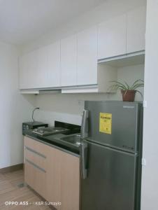 a kitchen with a stainless steel refrigerator and a sink at Condo with Balcony in Iloilo City in Iloilo City