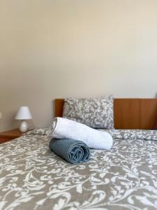 a pair of towels sitting on top of a bed at Faros Axd Odysseus Apartment in Alexandroupoli
