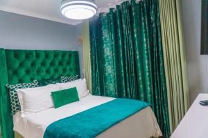 a bedroom with a green headboard and green curtains at Homes of Ace 3 bedroom Villa in Pretoria +23 photos