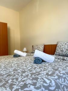 a bedroom with a bed with towels on it at Faros Axd Odysseus Apartment in Alexandroupoli +8 photos
