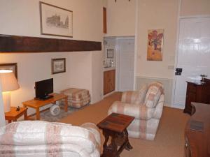 a living room with two couches and a tv at Town Mills in Dulverton