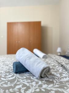 two towels sitting on top of a bed at Ground Apartment AXD in Alexandroupoli