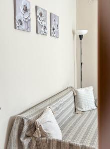 a bedroom with a bed with three pictures on the wall at Ground Apartment AXD in Alexandroupoli +8 photos