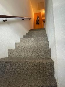 una escalera en un edificio con una persona caminando por él en 3-Zimmer Maisonette-Wohnung, en Bürchen