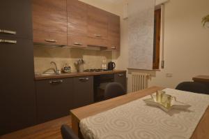 uma cozinha com uma mesa, um lavatório e um balcão em Appartamento Val d'Orcia Patri em Piancastagnaio