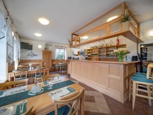 a restaurant with tables and chairs and a counter at Penzion a restaurace Lemberk in Jablonné v Podještědí