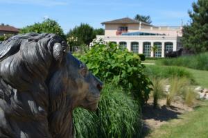 a statue of a lion in front of a house at Hôtel du Bois Blanc Domaine d'Epeyssoles Georges Blanc in Vonnas