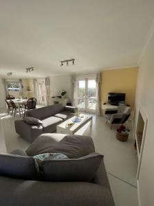 a living room with a couch and a table at Die Steenhuisie in Pringle Bay