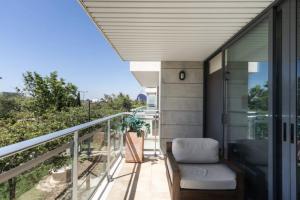 a balcony of a house with a chair at Art and Sciences view luxury apartment in Valencia