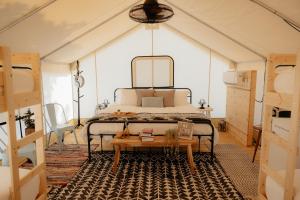 a bedroom with a bed in a tent at XLg Porch Deluxe glamping tents @ Lake Guntersville State Park in Guntersville