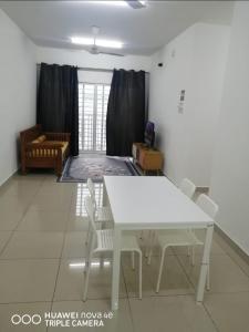 a white table and chairs in a living room at Rizqi Homestay Seruling in Putrajaya +3 photos