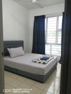 a bed in a room with a large window at Rizqi Homestay Seruling in Putrajaya