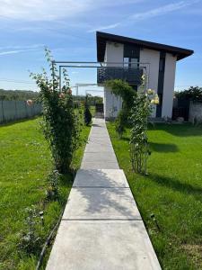 a walkway in front of a house in a field at Mimi house in Baia de Fier