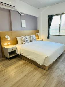 מיטה או מיטות בחדר ב-Qing Taoyuan Homestay