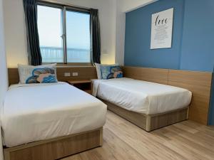 מיטה או מיטות בחדר ב-Qing Taoyuan Homestay
