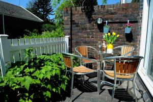 a patio with a table and chairs and a fence at Newly refurbished town house in Warwick in Warwick