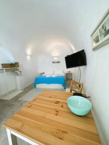 a room with a table with a bowl on it at Lioyerma Cave Villa With Private Outdoor Hot Tub in Oia