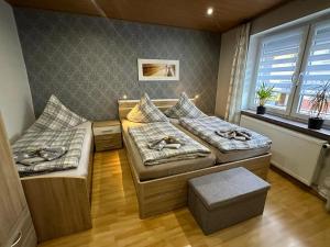 a room with two beds and a window at Christels Ferienwohnung 2 in Thale mit überdachter Terrasse, Küche mit TV & Geschirrspüler in Thale