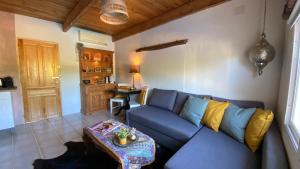 a living room with a blue couch and a table at Finca del Gecko in Alhaurín el Grande
