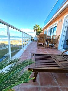 a balcony with chairs and tables and a view of the ocean at MIRADOR in Denia