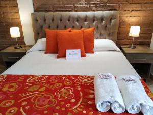 a hotel room with a bed with towels on it at Luna de Cafayate Hotel Boutique in Cafayate