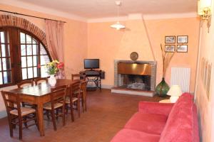 a living room with a table and a fireplace at Agriturismo la Torre in Bagni di Lucca