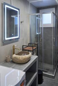 a bathroom with a stone sink and a shower at The sunny house in Athens