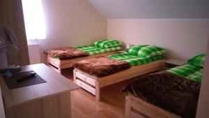 a room with three bunk beds and a table at Pokoje Gościnne u Agaty in Starogard Gdański +40 photos