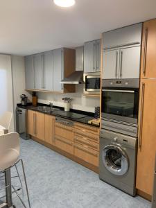 a kitchen with a washing machine and a washer at Art and Sciences view luxury apartment in Valencia