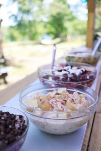 three bowls of food sitting on a table at Grinda Stugby och Sea Lodge - Pensionat med kost & logi in Grinda