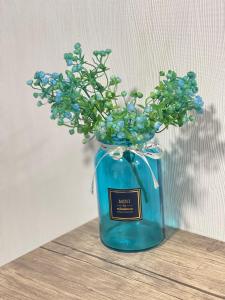 a blue jar with blue flowers in it on a table at Guest House Royal Comfort With Terrace in Kutaisi