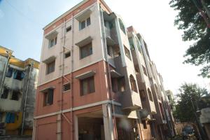 a red and white building on the side of a street at IZI APOLLO STAY in Chennai