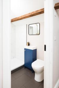 a bathroom with a blue cabinet and a toilet at Bankers Room + Kitchenette in Chapel en le Frith