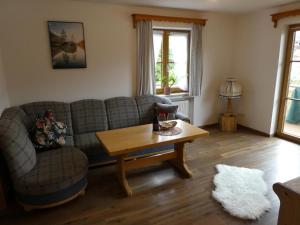 a living room with a couch and a coffee table at Ferienwohnung Finzblick in Wallgau