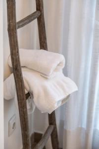 a stack of towels on a ladder next to a shower at Art and Sciences view luxury apartment in Valencia