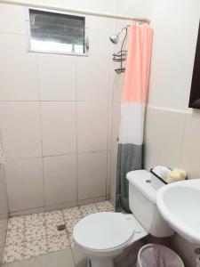 a bathroom with a toilet and a sink at Villa San Valentin in San Pedro Sula