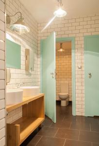 a bathroom with a sink and a toilet at Montis Hotel & Spa in Poniatowa