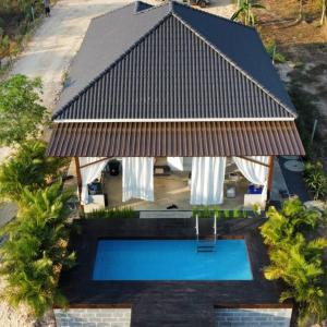 an overhead view of a house with a swimming pool at ฺBaannoi in the garden บ้านน้อยกลางทุ่ง Pool villa 